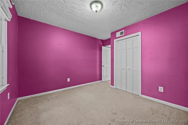a view of a livingroom with a ceiling fan and window