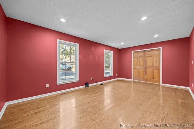 a view of a kitchen with wooden floor and a ceiling fan
