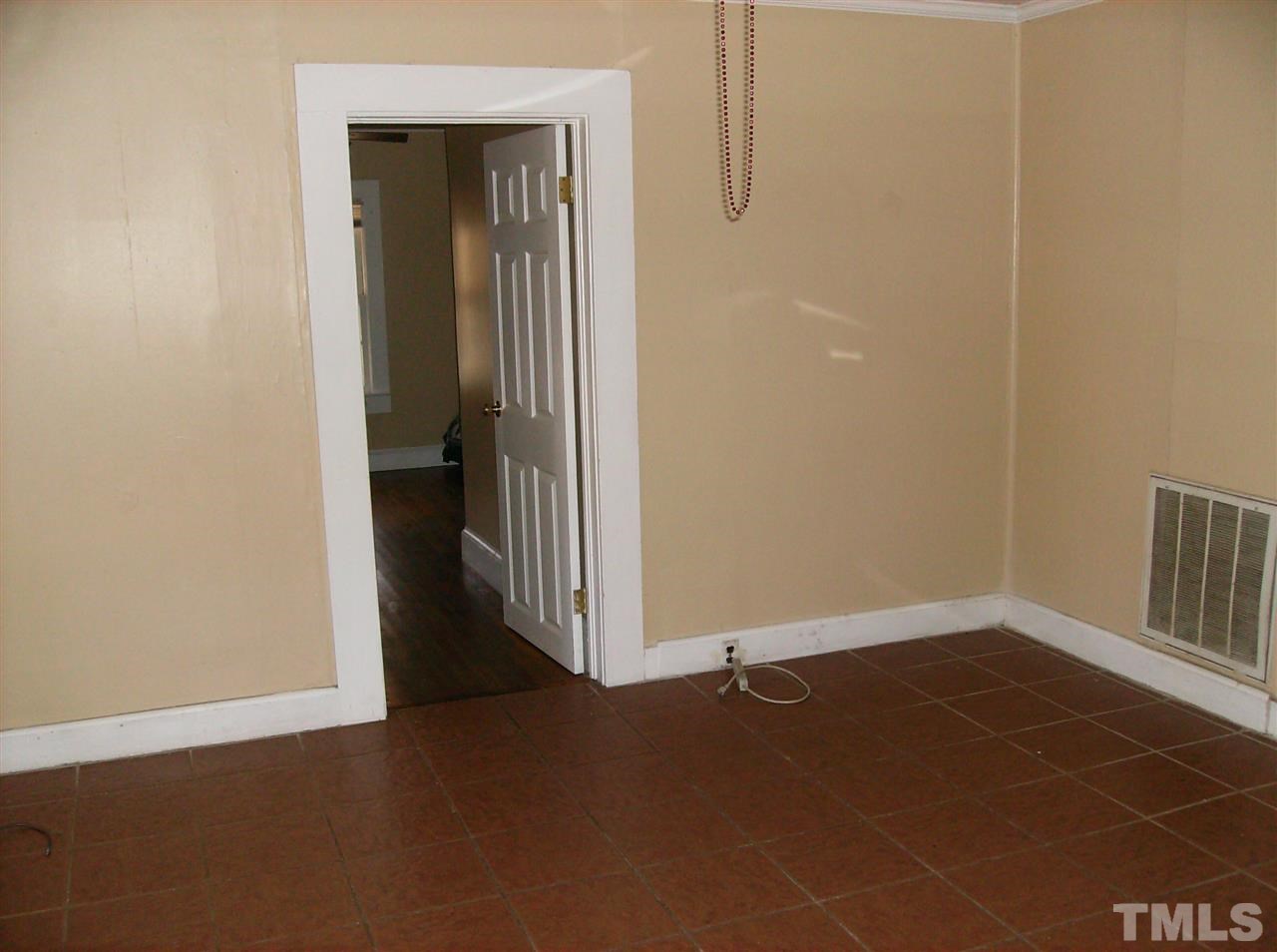 1272 Ridge Road Roxboro, NC 27573 - Photo 5 of 8 an empty room with a door