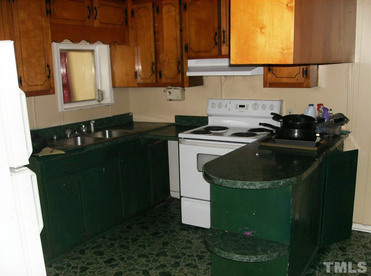 1272 Ridge Road Roxboro, NC 27573 - Photo 7 of 8 a kitchen with sink a refrigerator and cabinets