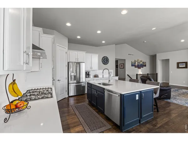 a kitchen with a sink appliances and wooden cabinets
