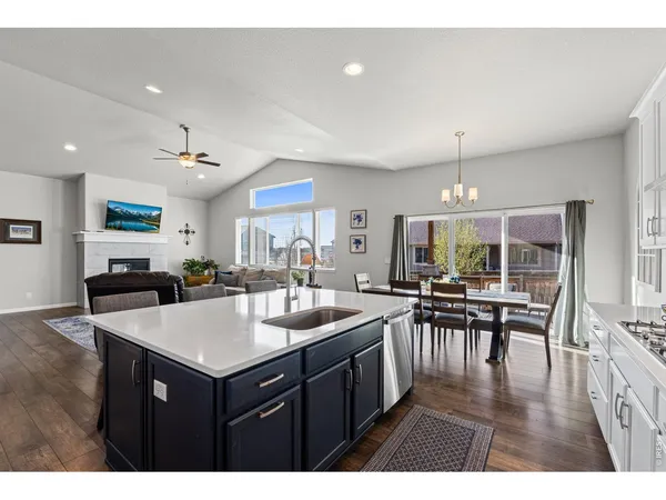 a kitchen with a dining table chairs and white cabinets