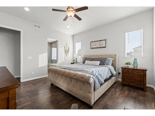a spacious bedroom with a bed and a chandelier