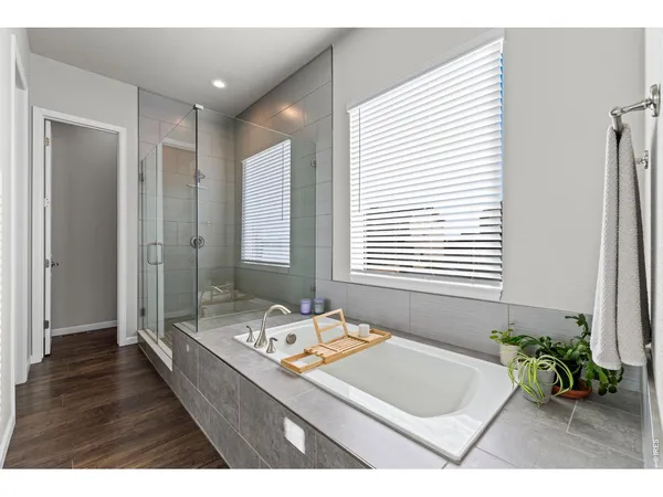 a bathroom with a tub sink and mirror
