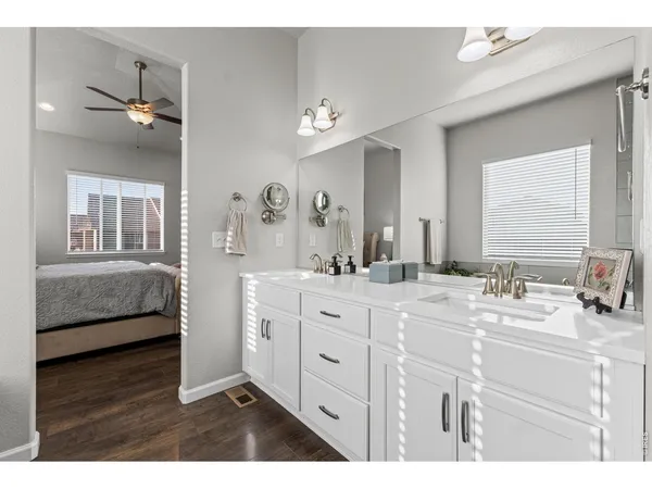 a bathroom with a double vanity sink a mirror and a