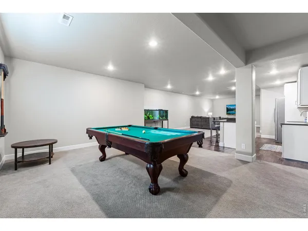 a living room with furniture a wooden floor and a sink