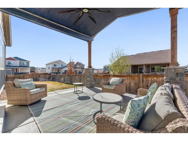a living room with furniture a fireplace and a floor to ceiling window