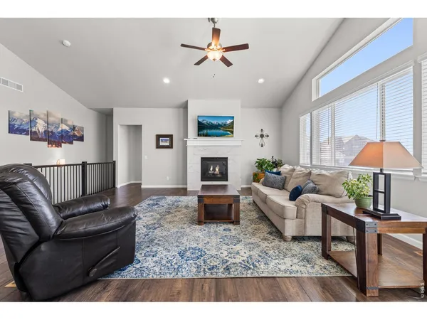 a living room with furniture a fireplace and a flat screen tv
