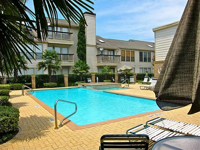 a view of a swimming pool with lounge chairs