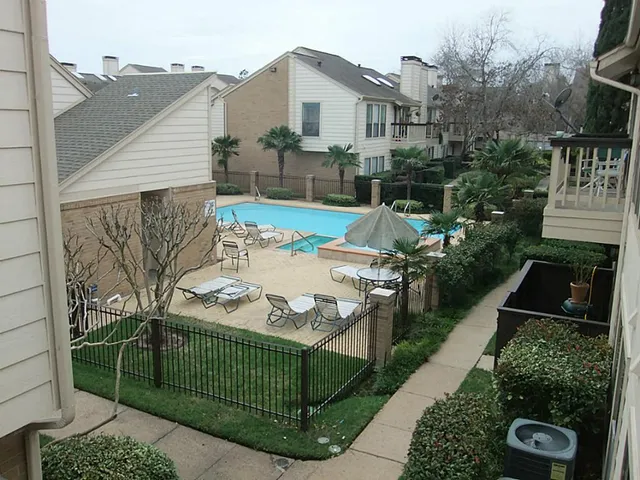 a view of a couches and table in the backyard