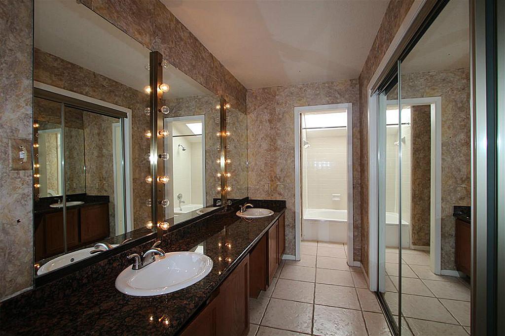 2277 South Kirkwood Road, Unit 708 Houston, TX 77077 - Photo 7 of 13 a bathroom with a sink double vanity granite tub and shower