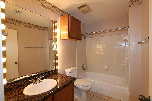 a bathroom with a sink toilet a mirror and shower
