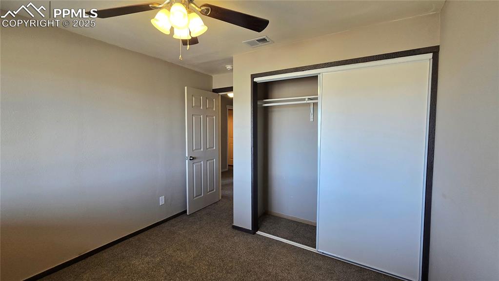 120 Sunset Drive Westcliffe, CO 81252 - Photo 16 of 20 an empty room with a chandelier fan and closet