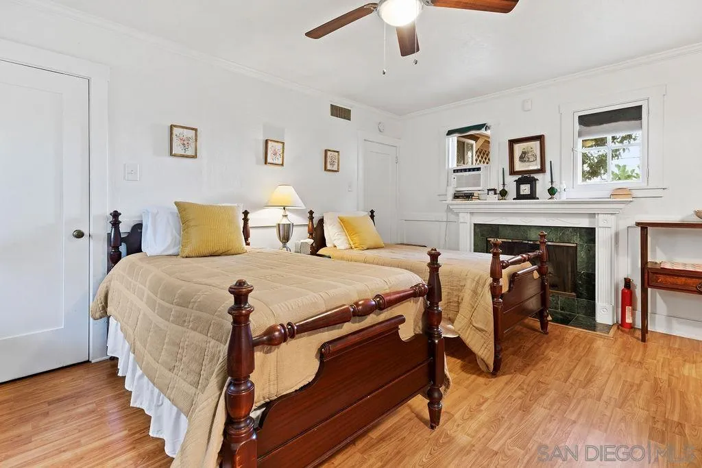 4531 Date Avenue La Mesa, CA 91941 - Photo 22 of 34 a bedroom with a bed and a fireplace