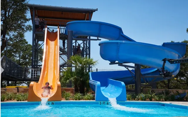 a sign board with buildings in the background