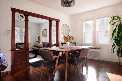 a view of a dining room with furniture window and wooden floor