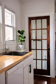 a bathroom with a granite countertop sink and a window
