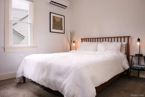 a large bed sitting in a bedroom next to a window