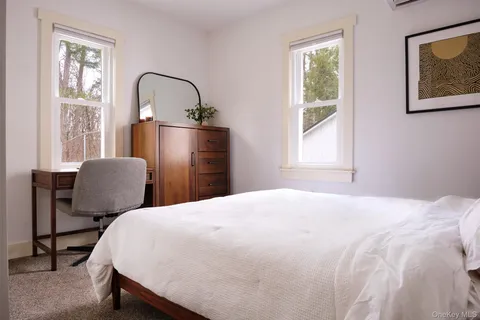 a bedroom with bed and a window