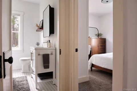 a en suite bathroom with a toilet sink and mirror