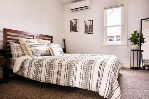 a bedroom with a bed and a window