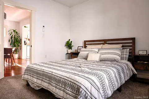 a bedroom with a bed and a potted plant