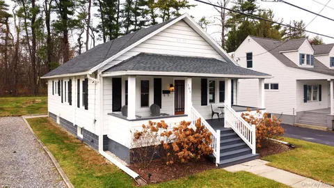 a front view of a house with a yard table and chairs