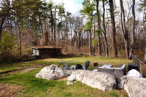 a view of a backyard with swimming pool
