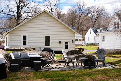 a backyard of a house with yard fire pit and outdoor seating