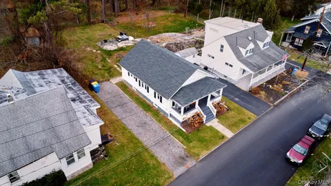 an aerial view of a house with a garden and swimming pool