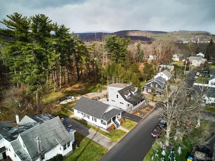 an aerial view of a house with a yard