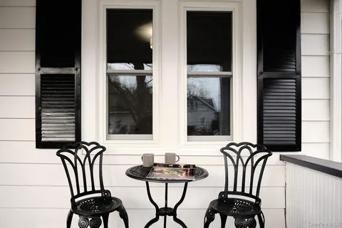 a view of two chairs in the balcony