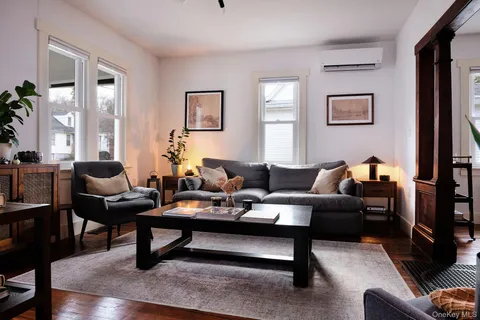 a living room with furniture and a potted plant