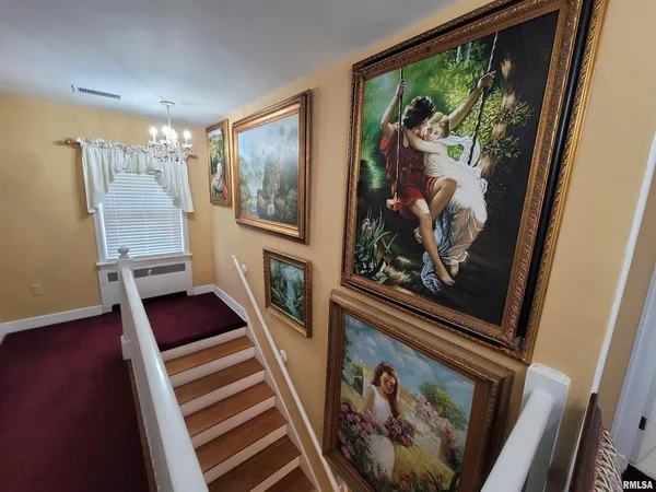 a view of entryway with furniture and wooden floor