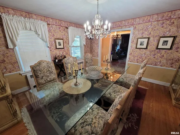 a bed room with a bed and a chandelier