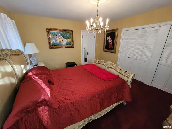 a bedroom with a bed and a television