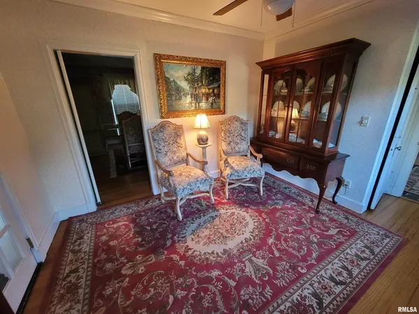 a living room with a rug and a table