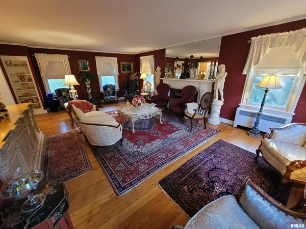 a living room with furniture a rug and a large window