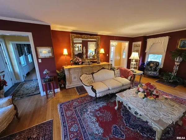 a living room with furniture a rug and a large window