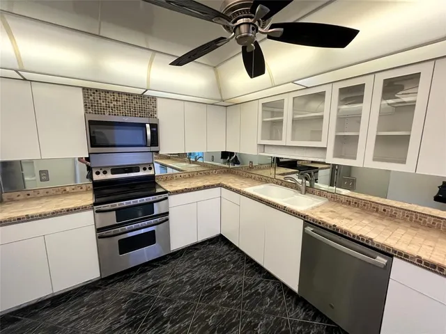 a kitchen with a stove and a refrigerator