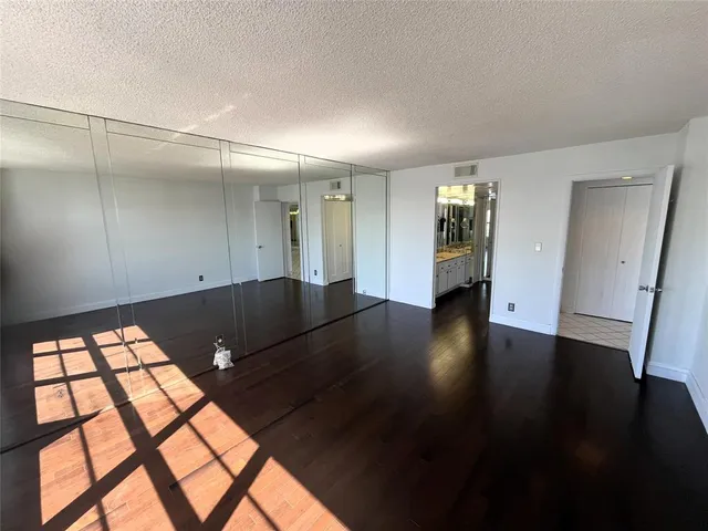 a bathroom with a granite countertop sink a shower and a mirror