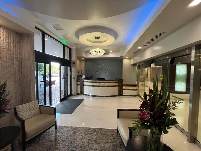 a lobby with furniture and a potted plant