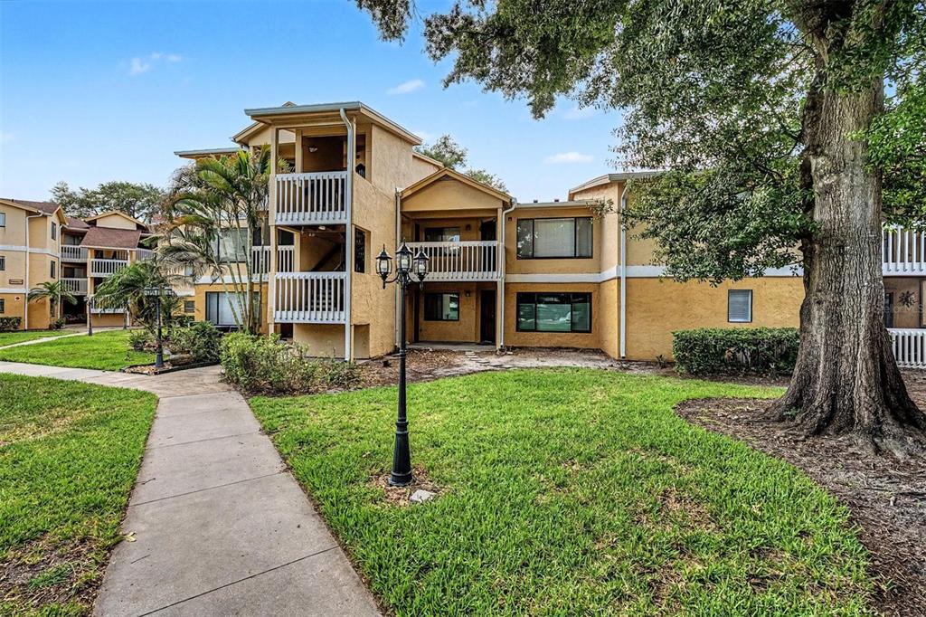 1550 South Belcher Road, Unit 525 Clearwater, FL 33764 - Photo 2 of 28 a front view of a house with a yard