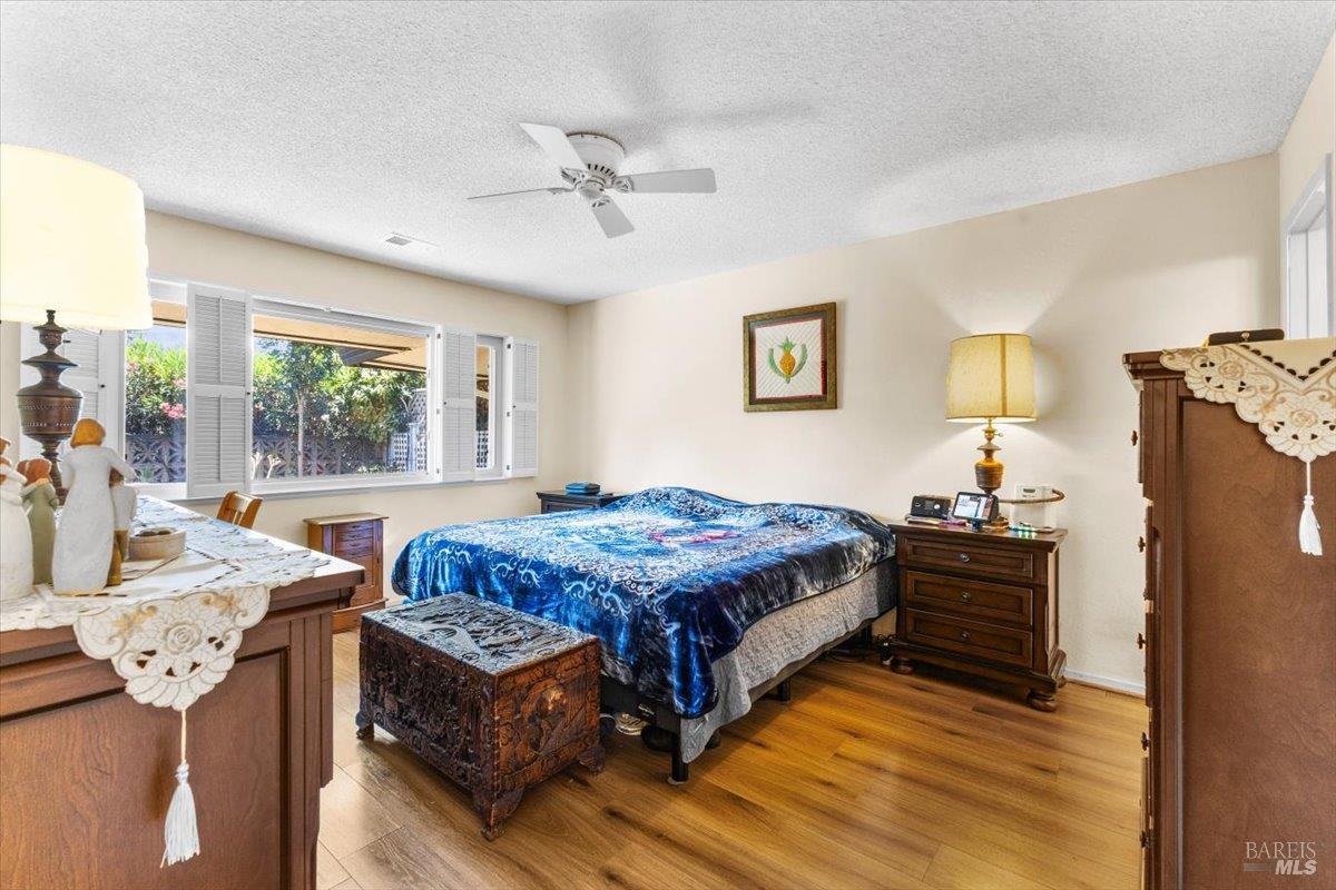 442 Las Casitas Court, Unit A Santa Rosa, CA 95403 - Photo 17 of 33 a bedroom with a bed and a chandelier