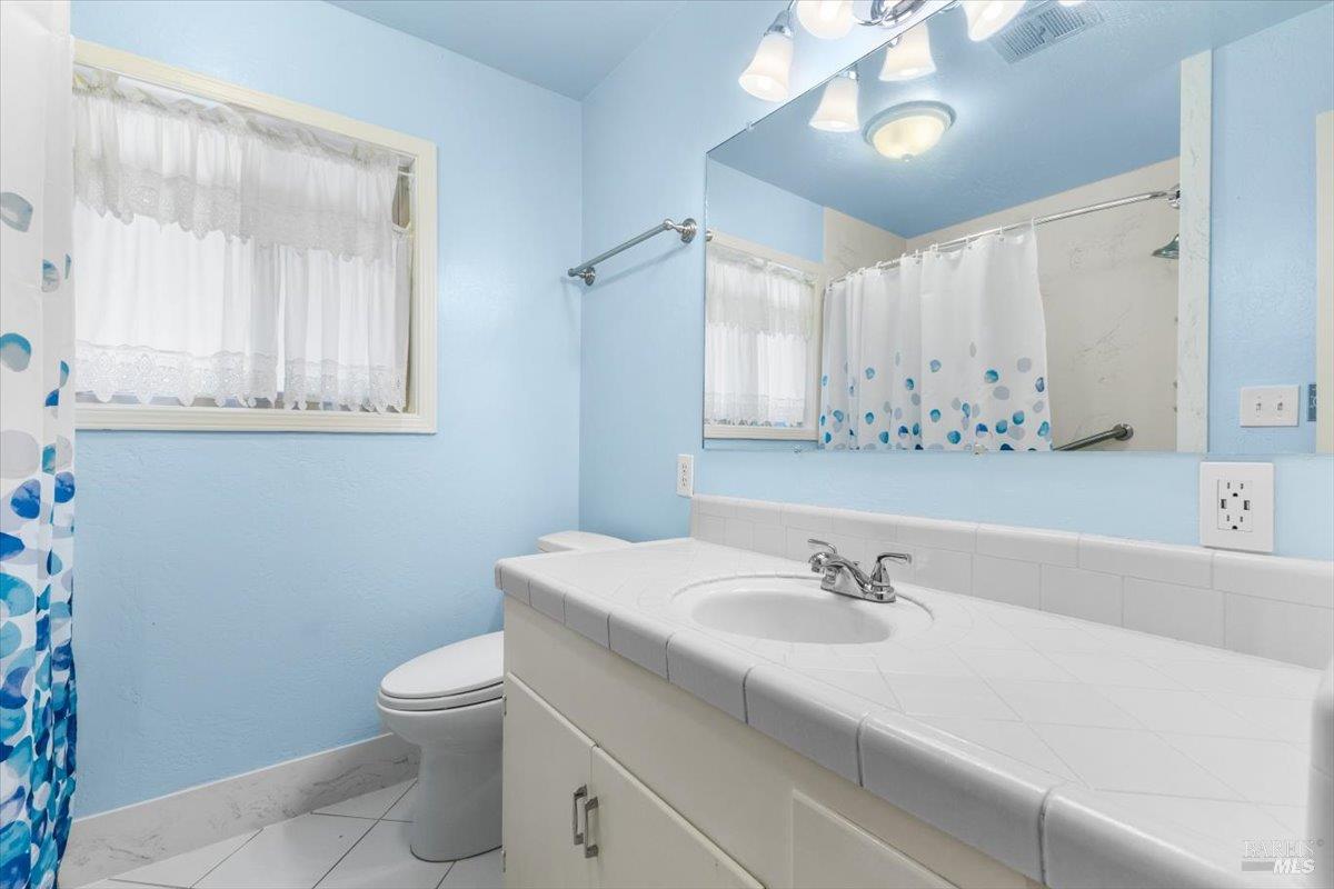 442 Las Casitas Court, Unit A Santa Rosa, CA 95403 - Photo 18 of 33 a bathroom with a sink toilet and a mirror