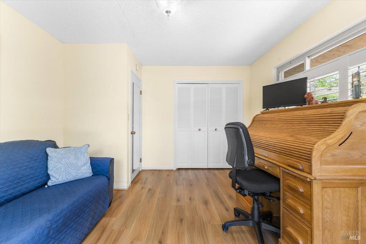 442 Las Casitas Court, Unit A Santa Rosa, CA 95403 - Photo 20 of 33 a bedroom with a bed and wooden floor