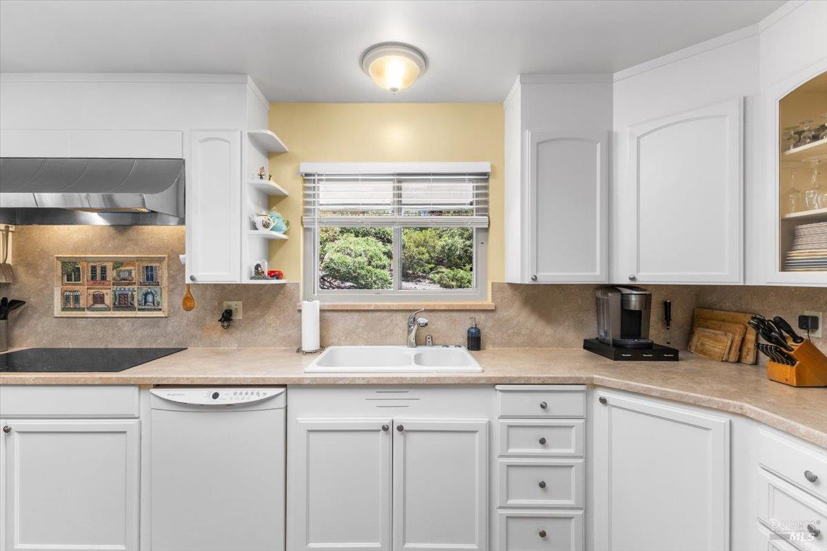 442 Las Casitas Court, Unit A Santa Rosa, CA 95403 - Photo 7 of 33 a kitchen with granite countertop a sink white cabinets and a window