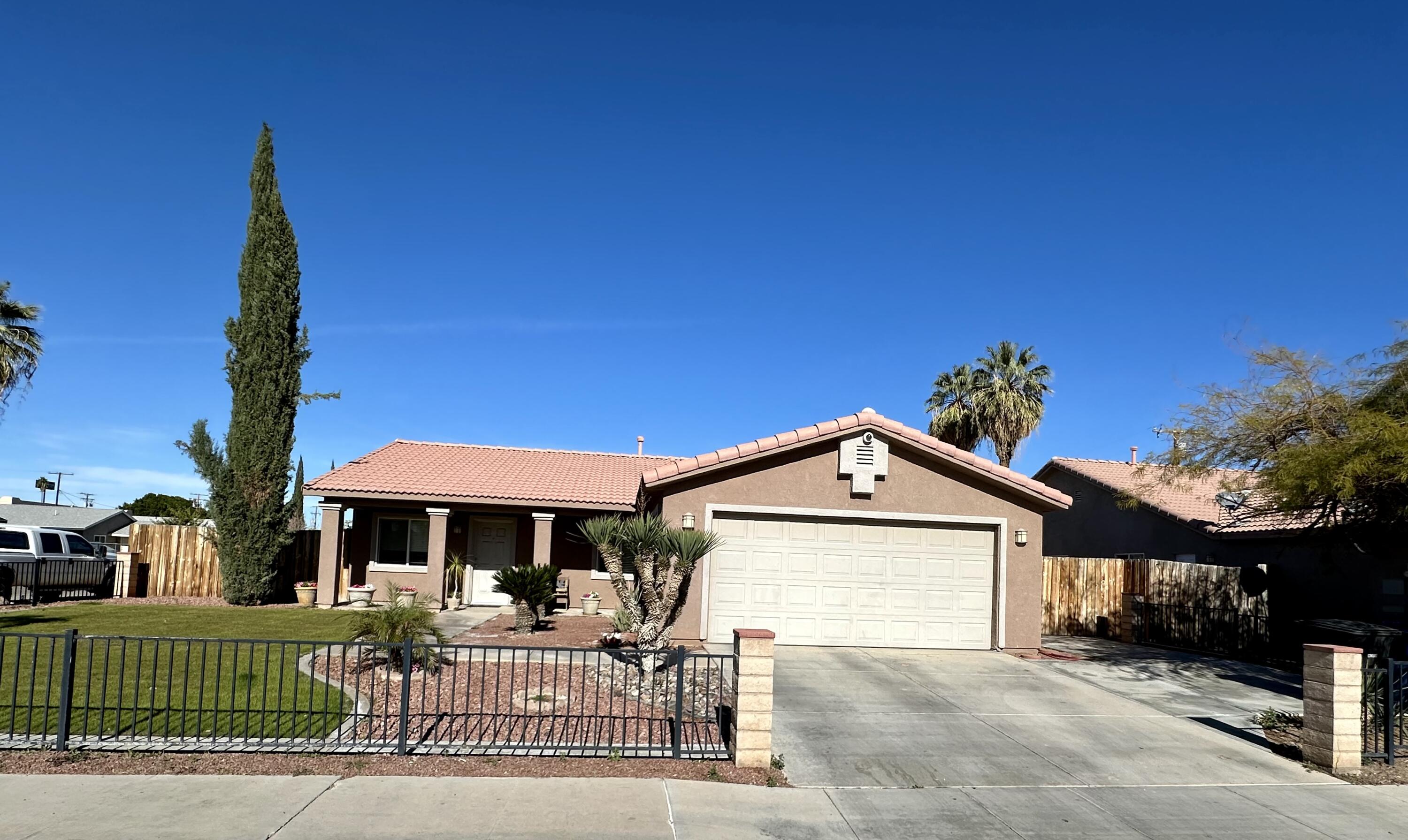 a front view of a house with a garden and deck