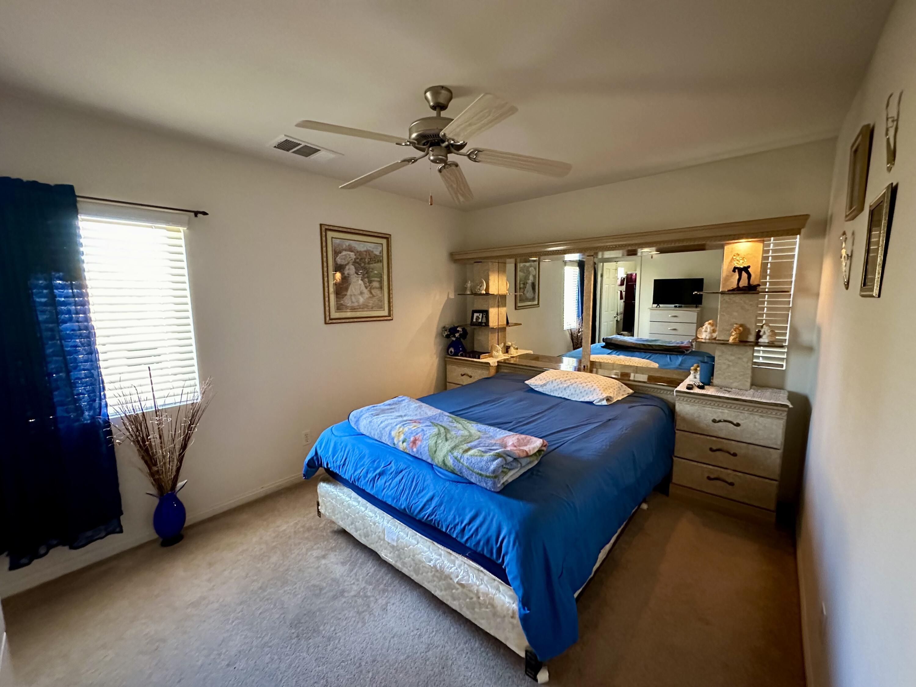 575 West Rice Street Blythe, CA 92225 - Photo 14 of 24 a bedroom with a bed window and couch