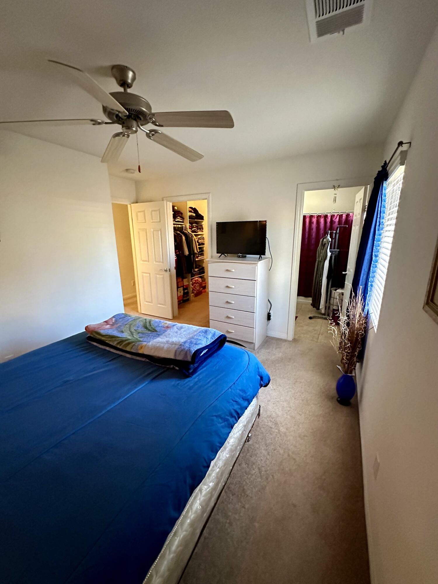 575 West Rice Street Blythe, CA 92225 - Photo 15 of 24 a bedroom with a bed and a flat tv screen on the dresser